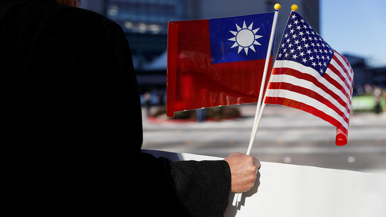 A demonstrator holds flags of Taiwan and the United States in support of Taiwanese President Tsai Ing-wen during an stop-over after her visit to Latin America in Burlingame